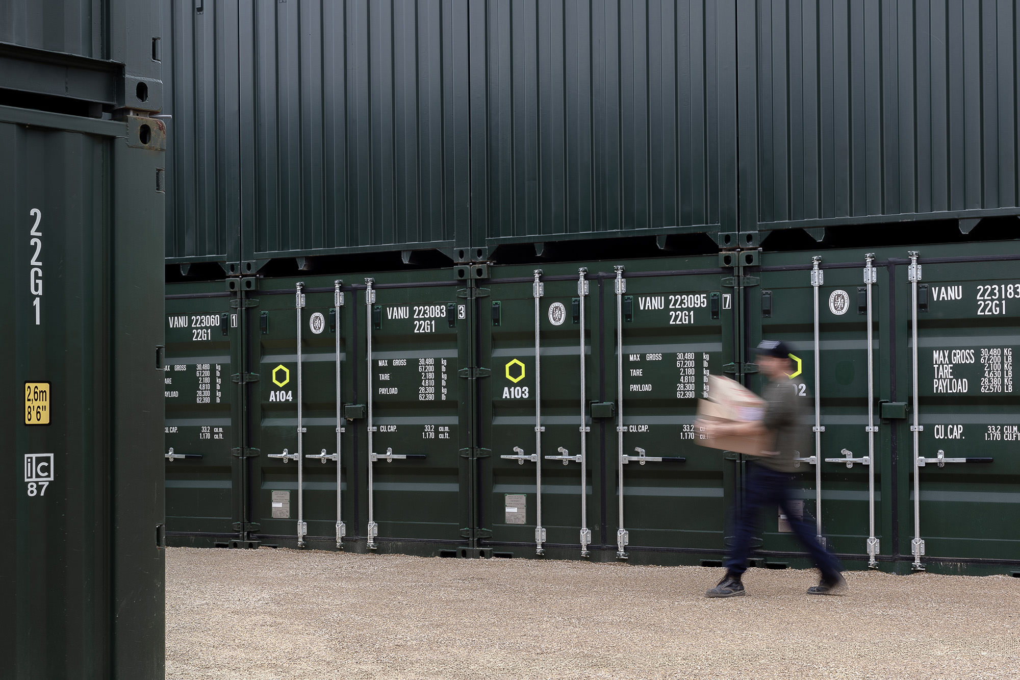 a person is moving boxes into a shipping container storage unit